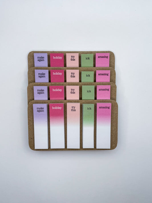 Set of cookbook tabs with 5 different words on a cardboard backing with white background.