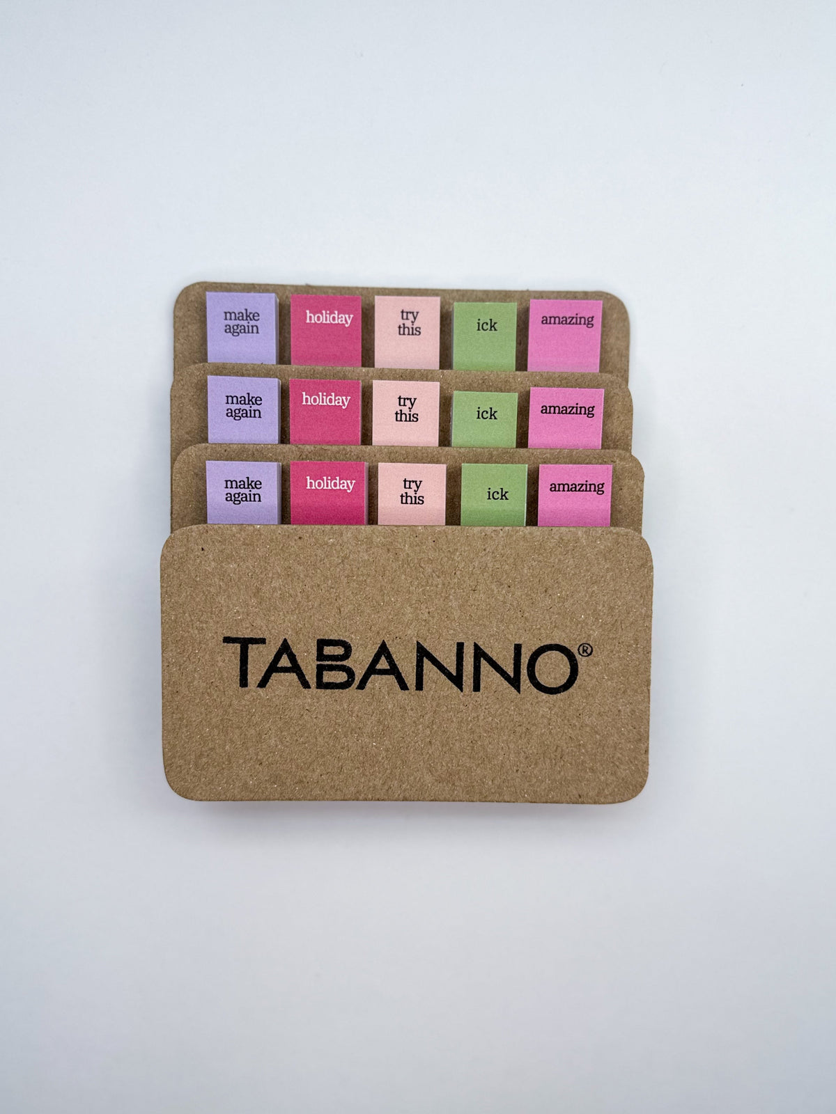 Set of cookbook tabs with 5 different words on a cardboard backing with white background. One of the cards is flipped around and reads Tabanno® on the back. 