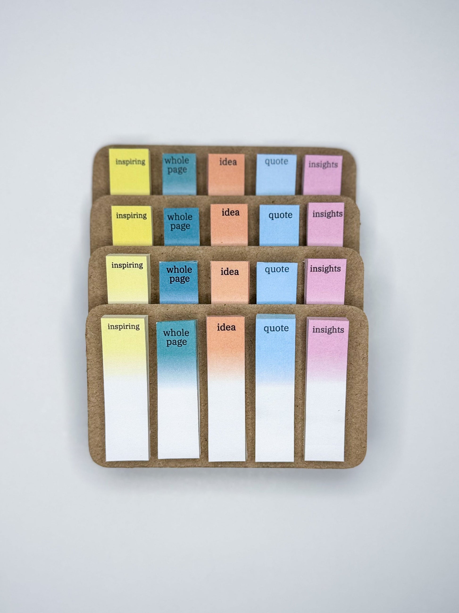 Set of colorful sticky notes in a wooden holder on a light gray background