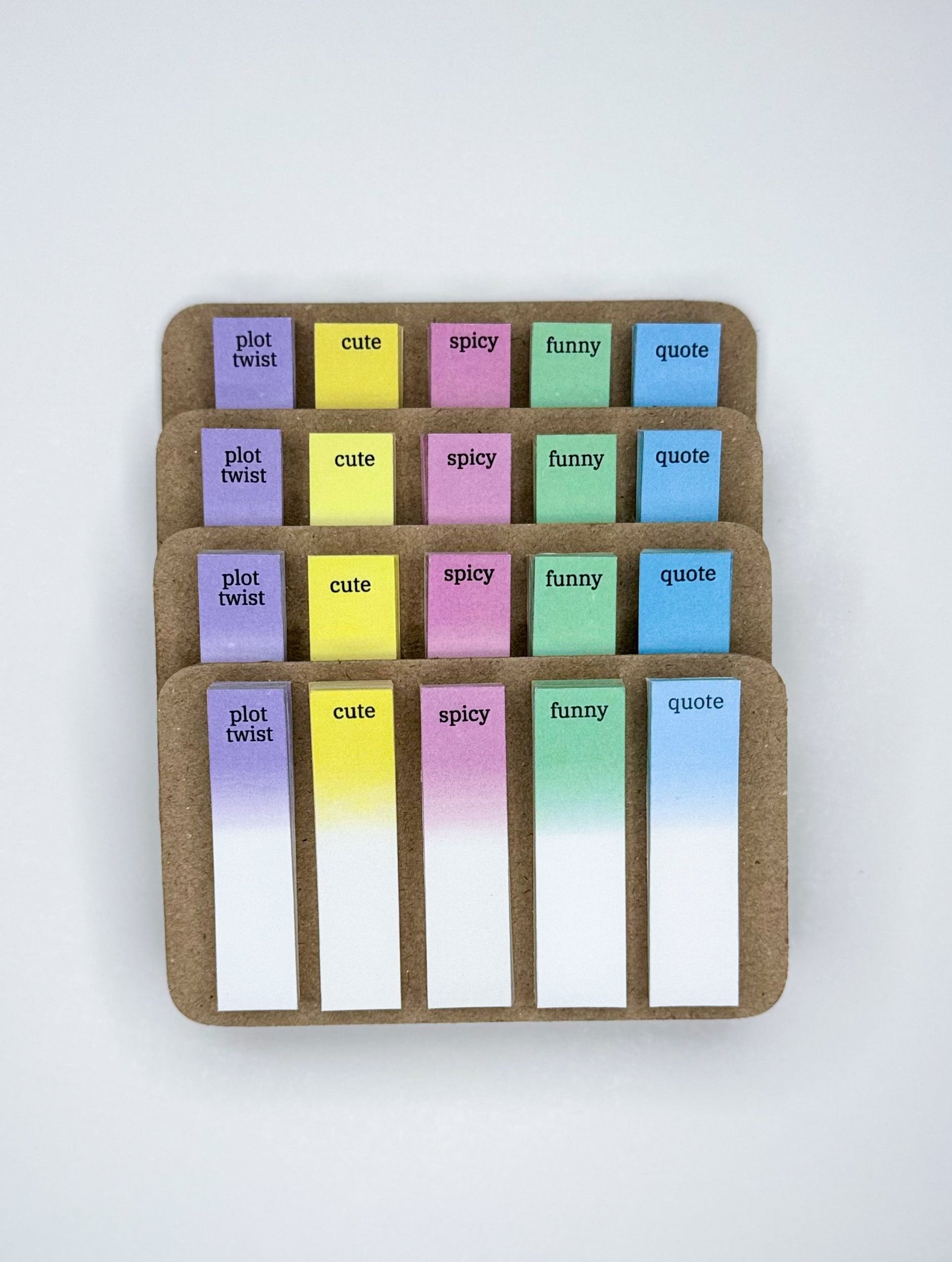 Set of colorful sticky notes in a cardboard holder on a white background