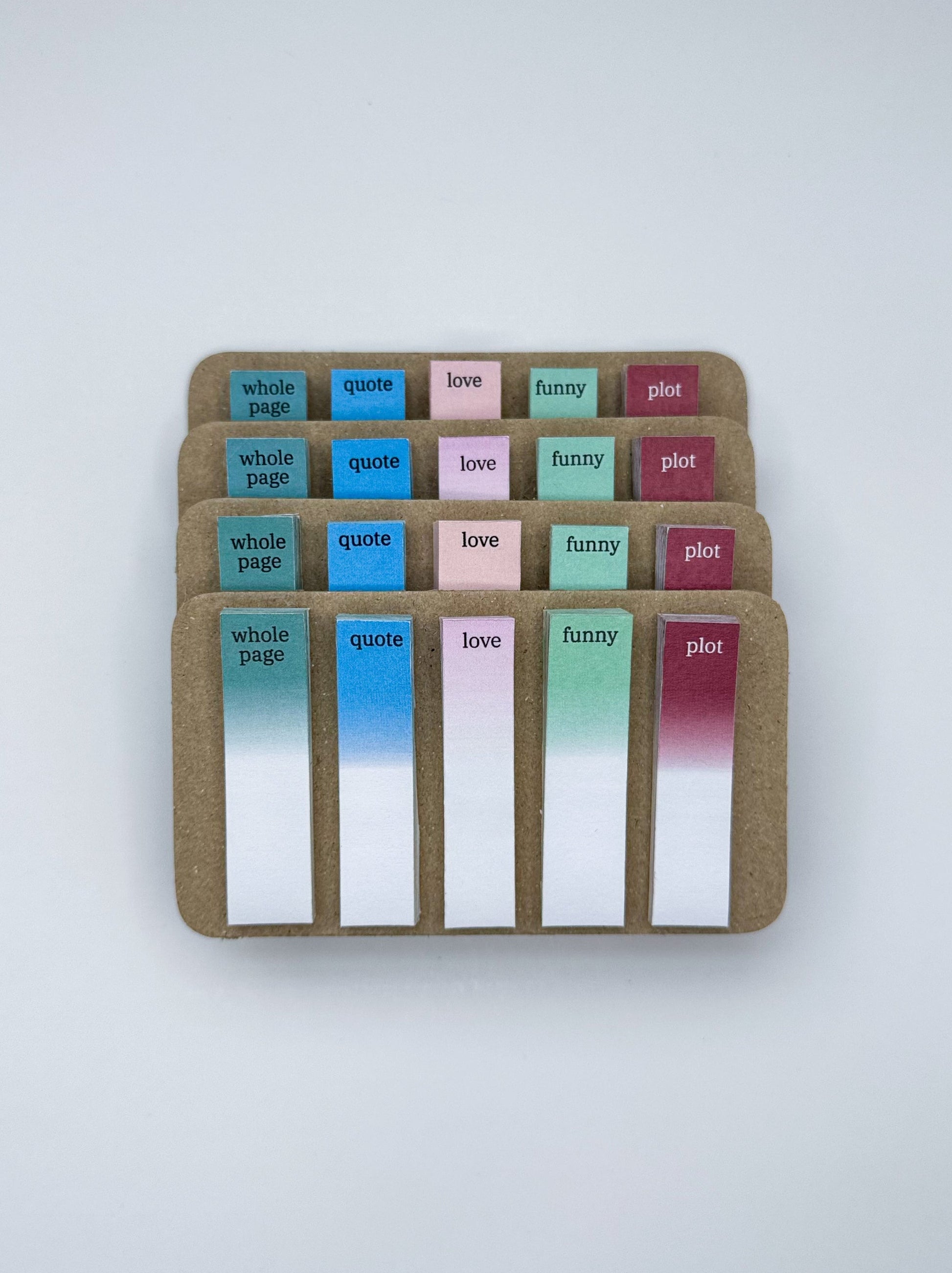 Set of colorful fiction sticky notes in a cardboard holder on a white background