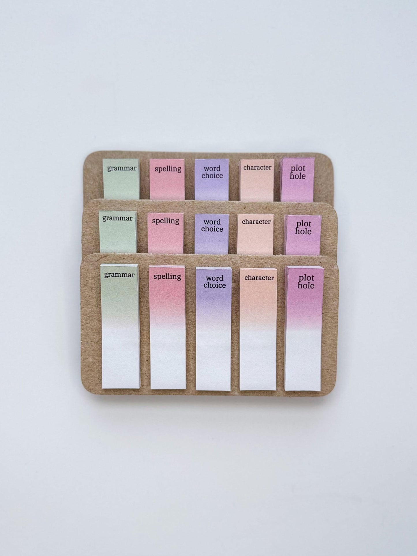 Set of colorful index cards in a cardboard holder on a white background